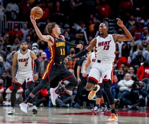 epa09701176 Atlanta Hawks guard Trae Young (L) in action against Miami Heat center Bam Adebayo (R) during the second half of the NBA basketball game between the Miami Heat and the Atlanta Hawks at State Farm Arena in Atlanta, Georgia, USA, 21 January 2022.  EPA/ERIK S. LESSER  SHUTTERSTOCK OUT