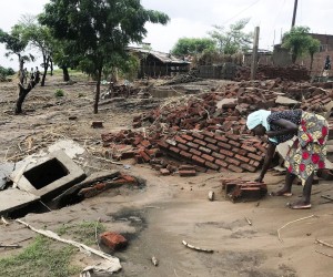 epa09711806 A woman looks for her belongings, after the Tropical Storm Ana hit the district of Tete, Mozambique, 27 January 2022. The number of deaths caused by Tropical Storm Ana in Mozambique has risen to 20 people according to data from local authorities and civil protection, and the population lives in a trail of destruction. The storm hit the country directly between Monday and Wednesday, but despite having already weakened and moved on to other countries (Zimbabwe and Zambia), the heavy rains have fed the flow of all rivers in central and northern Mozambique, which continue to cause flooding.  EPA/ANDRE CATUEIRA