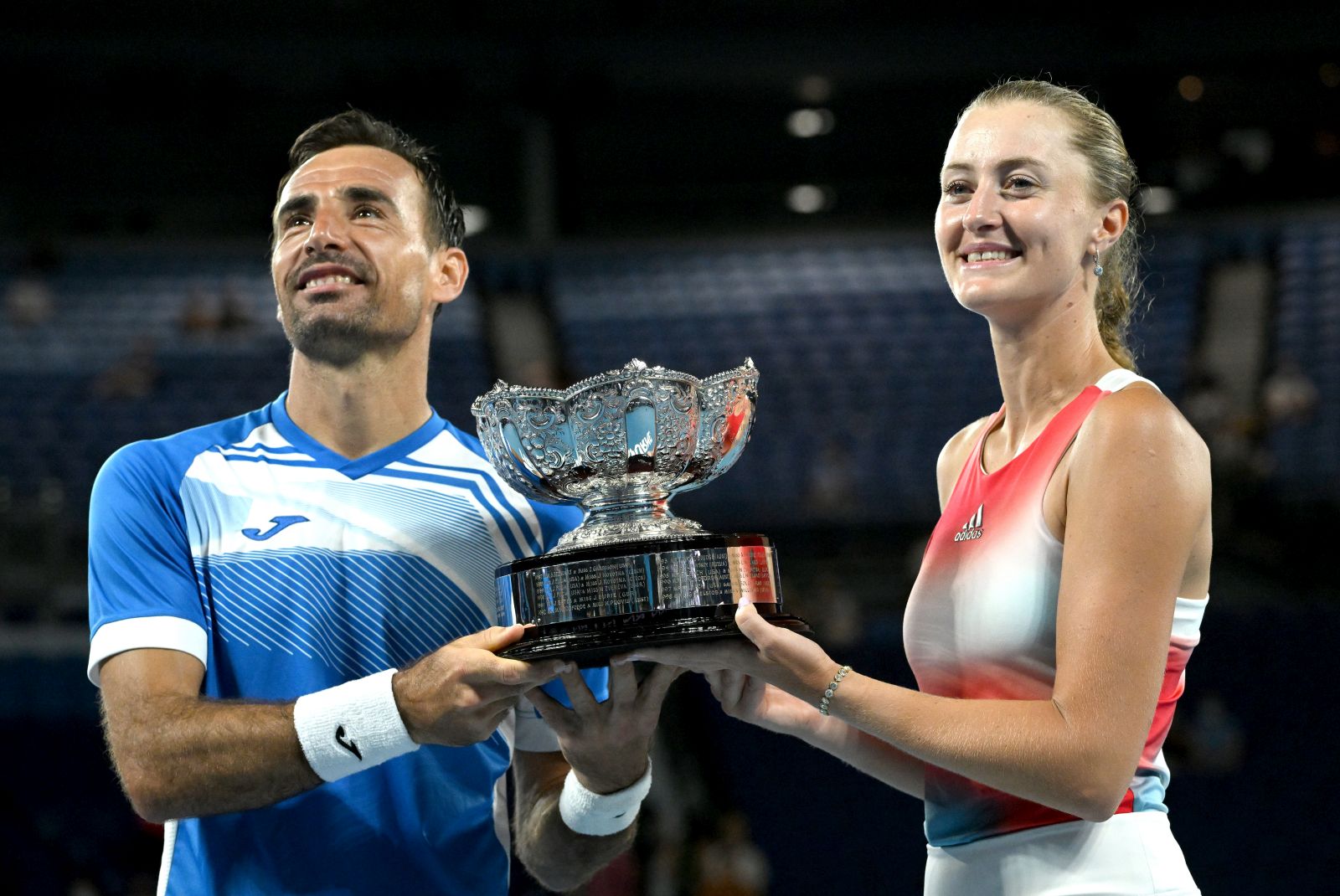 epa09713568 Ivan Dodig of Croatia (L) and Kristina Mladenovic of France pose with the winners trophy after their Mixed Doubles Final win against Jaimee Fourlis and Jason Kubler of Australia at the Australian Open Grand Slam tennis tournament at Melbourne Park, in Melbourne, Australia, 28 January 2022.  EPA/DEAN LEWINS AUSTRALIA AND NEW ZEALAND OUT
