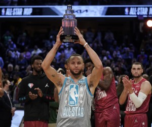 Golden State Warriors' Stephen Curry holds up the Kobe Bryant Trophy after being named the MVP of the NBA All-Star basketball game, Sunday, Feb. 20, 2022, in Cleveland. (AP Photo/Charles Krupa)