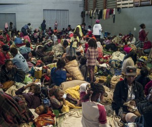 epa09705191 Madagascan disaster victims take refuge in the gymnasium of Ankorondrano after being displaced from flooding from a tropical cyclone in the capital Antananarivo, Madagascar, 23 January 2022. Heavy rains and wind from the tropical weather system crossed the island late 22 January 2022 causing flooding and landslides. According to the interior ministry at least 10 deaths have been reported from landslides. So far 500 people have been displaced by the storm.  EPA/HENITSOA RAFALIA