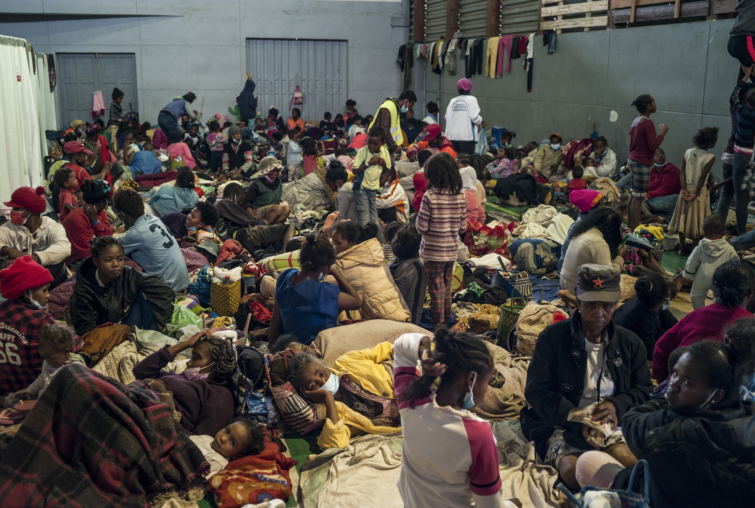 epa09705191 Madagascan disaster victims take refuge in the gymnasium of Ankorondrano after being displaced from flooding from a tropical cyclone in the capital Antananarivo, Madagascar, 23 January 2022. Heavy rains and wind from the tropical weather system crossed the island late 22 January 2022 causing flooding and landslides. According to the interior ministry at least 10 deaths have been reported from landslides. So far 500 people have been displaced by the storm.  EPA/HENITSOA RAFALIA