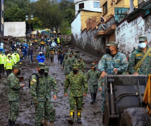 epa09721350 Soldiers help in the cleaning work on the mudslide caused by the rains of 31 January, which affected some neighborhoods in the west of the Ecuadorian capital and caused at least 18 fatalities, as reported by the authorities in Quito, Ecuador, 01 February 2022. The number of people who died on 31 January rose to 18 after a flood that affected several neighborhoods in the west of the Ecuadorian capital, a city that was hit by a heavy downpour, with record rainfall, according to authorities.  EPA/Jose Jacome