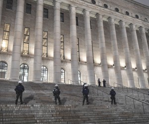 epa09728262 Police stand guard in front of the Parliament House during the Freedom Convoy Finland 2022 demonstration in Helsinki, Finland, 04 February 2022. The protest calls for a halving of fuel taxation, the abolition of all Coronavirus measures and the resignation of the Finnish government.  EPA/KIMMO BRANDT