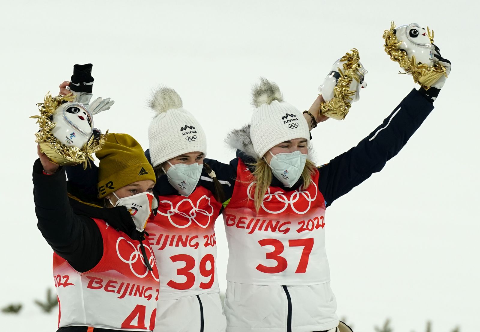 epa09729883 Winner Ursa Bogataj of Slovenia (C), second placed Katharina Althaus of Germany (L) and third placed Nika Kriznar of Slovenia (R) celebrate after the Women's Ski Jumping Normal Hill final at the Zhangjiakou National Ski Jumping Centre at the Beijing 2022 Olympic Games, Zhangjiakou, China, 05 February 2022.  EPA/Kimimasa Mayama