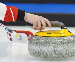 epa09730131 Jenny Perret of Switzerland releases her stone during the Curling mixed doubles preliminary round game between the Czech Republic and Switzerland at the Beijing 2022 Olympic Games in Beijing, China, 05 February 2022.  EPA/SALVATORE DI NOLFI