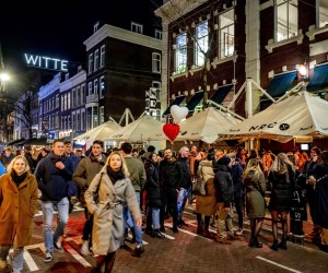 epa09748007 Partygoers crowd a street in the Witte de Witstraat in Rotterdam, The Netherlands, late 11 February 2022. The Dutch cabinet aims to have most coronavirus pandemic restrictive measures come to an end soon.  EPA/ROBIN UTRECHT