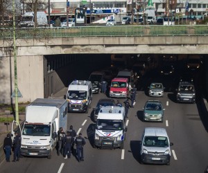 epa09749361 French police forces stand at a checkpoint on the Paris ring road to prevent members of the 'Freedom Convoy' from entering Paris, France, 12 February 2022. Paris police have prohibited the convoy, as announced by the capital’s prefect on 10 February. A series of convoy demonstrations has been taking place in France to call for the lifting of all Covid-19-related restrictions and mandates, in light of the ongoing protest in Canada, where truck drivers have been rallying against the government-imposed mandatory Covid-19 vaccine to enter the country.  EPA/CHRISTOPHE PETIT TESSON