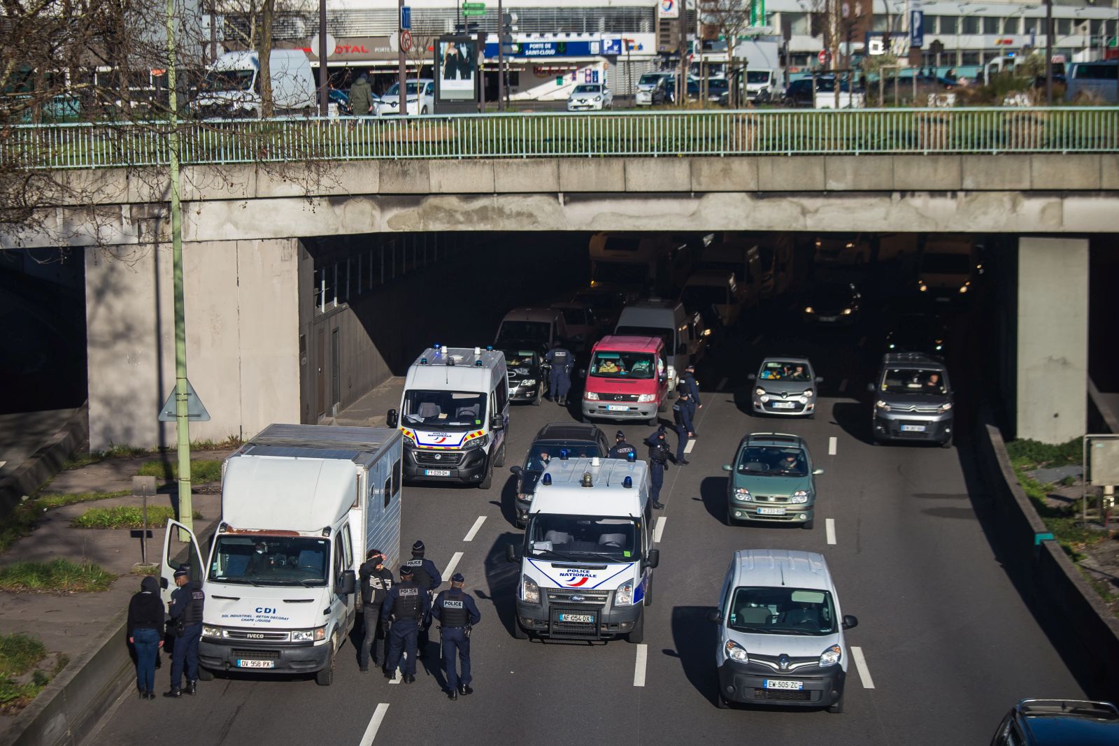 epa09749361 French police forces stand at a checkpoint on the Paris ring road to prevent members of the 'Freedom Convoy' from entering Paris, France, 12 February 2022. Paris police have prohibited the convoy, as announced by the capital’s prefect on 10 February. A series of convoy demonstrations has been taking place in France to call for the lifting of all Covid-19-related restrictions and mandates, in light of the ongoing protest in Canada, where truck drivers have been rallying against the government-imposed mandatory Covid-19 vaccine to enter the country.  EPA/CHRISTOPHE PETIT TESSON