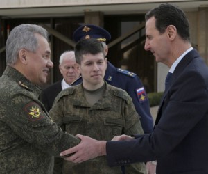 epa09759815 A handout image made available by the Russian Defence Ministry press service shows Russian Defense Minister General of the Army Sergei Shoigu (L) shakes hands with Syrian President Bashar al-Assad (R) during their meeting in Damascus, Syria, 15 February 2022.  EPA/RUSSIAN DEFENCE MINISTRY PRESS SERVICE/HANDOUT MANDATORY CREDIT HANDOUT EDITORIAL USE ONLY/NO SALES
