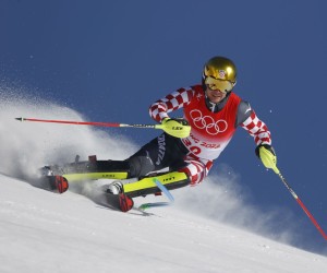 epa09760888 Samuel Kolega of Croatia clears a gate during the second run of the Men's Slalom race of the Alpine Skiing events of the Beijing 2022 Olympic Games at the Yanqing National Alpine Ski Centre Skiing, Beijing municipality, China, 16 February 2022.  EPA/GUILLAUME HORCAJUELO