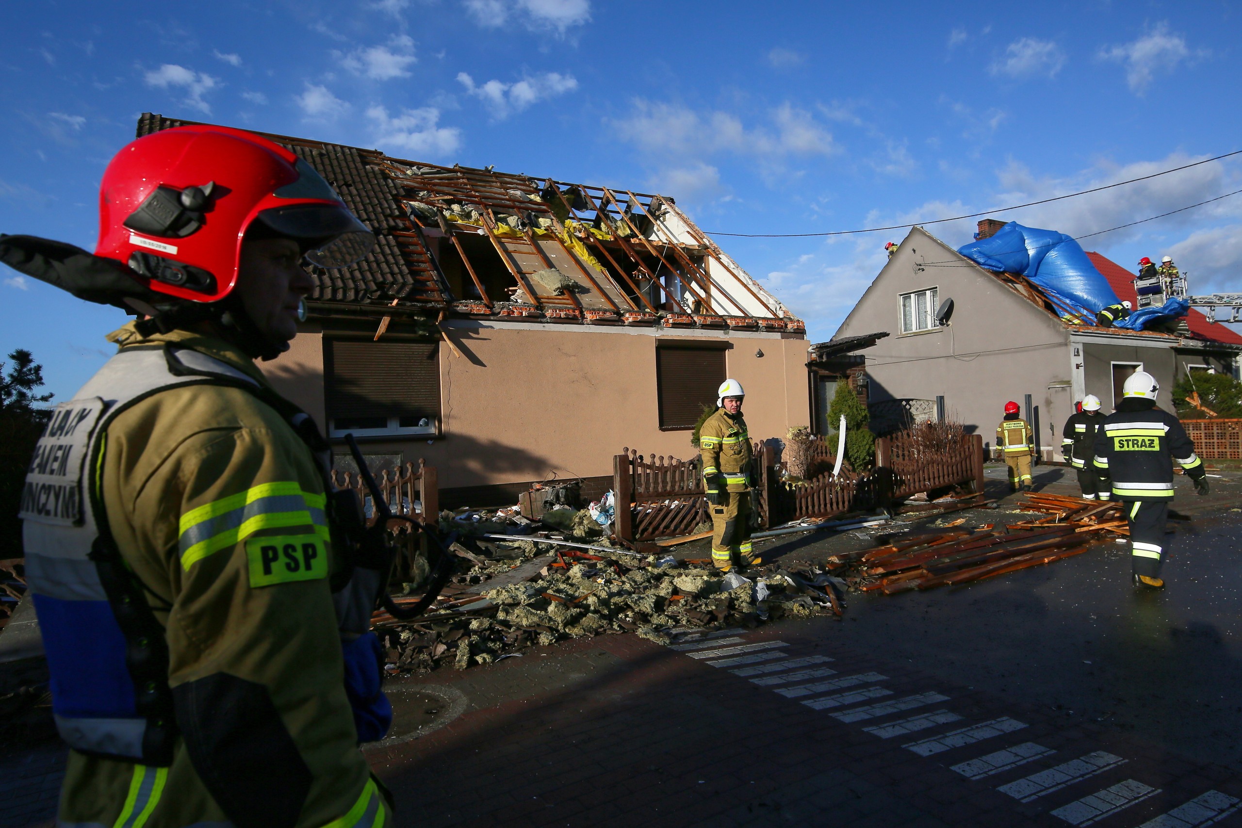 epa09765065 Polish firefighters protect and secure a broken roof of a residential building after strong winds in the night in Dobrzyca, Poland, 17 February 2022. The Institute of Meteorology and Water Management issued a warning concerning strong winds in Poland.  EPA/Tomasz Wojtasik POLAND OUT