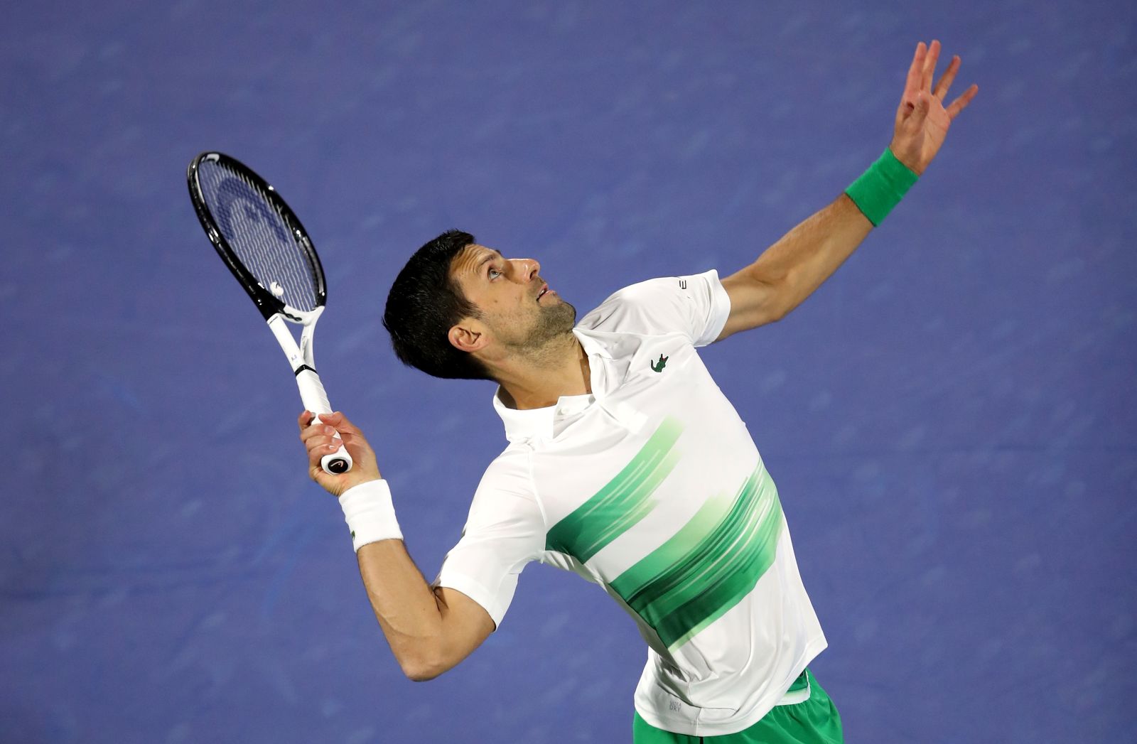 epa09776017 Novak Djokovic of Serbia serves during his first round match against Lorenzo Musetti of Italy at the Dubai Duty Free Tennis ATP Championships 2022 in Dubai, United Arab Emirates, 21 February 2022.  EPA/ALI HAIDER