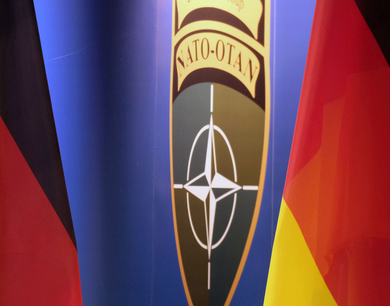 epa09777034 A view of Germany national flags and the logo of the NATO enhanced Forward Presence (EFP) Battalion Battle Group are pictured during a joint press conference of the German and Lithuanian defense ministers at Rukla Military Base, Lithuania, 22 February 2022. German Defence Minister Lambrecht visited Rukla due to regional tensions concerning a probable Russian invasion into Ukraine, bilateral cooperation on defense, and other pressing issues. Germany is leading a NATO-led battlegroup in Lithuania with more than 1,000 troops, one of four missions NATO sent to the Baltic states and Poland in 2017 in response to Russia's annexation of Ukraine's Crimean peninsula in 2014. Germany, one of Lithuania's key allies in security and defense, has recently sent additional 350 troops to Lithuania in response to the increasing tensions over Russian military activity near the Ukrainian borders and over concerns for the security environment in the Baltics.  EPA/VALDA KALNINA