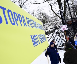 epa09778507 A man holds a banner reading 'Stop Putin's aggressions against Ukraine' during a protest outside the Russian embassy in Stockholm, Sweden, 23 February 2022.  EPA/Paul Wennerholm/TT  SWEDEN OUT