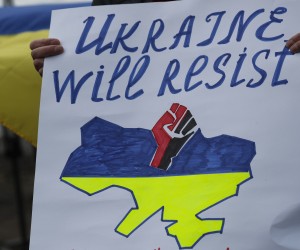 epa09780342 A person holds a placard as people protest against Russia's military operation in Ukraine, outside the Russian Embassy in Riga, Latvia, 24 February 2022. Russian troops entered Ukraine on 24 February. Country's President Volodymyr Zelensky addressed the nation to announce the imposition of martial law.  EPA/TOMS KALNINS