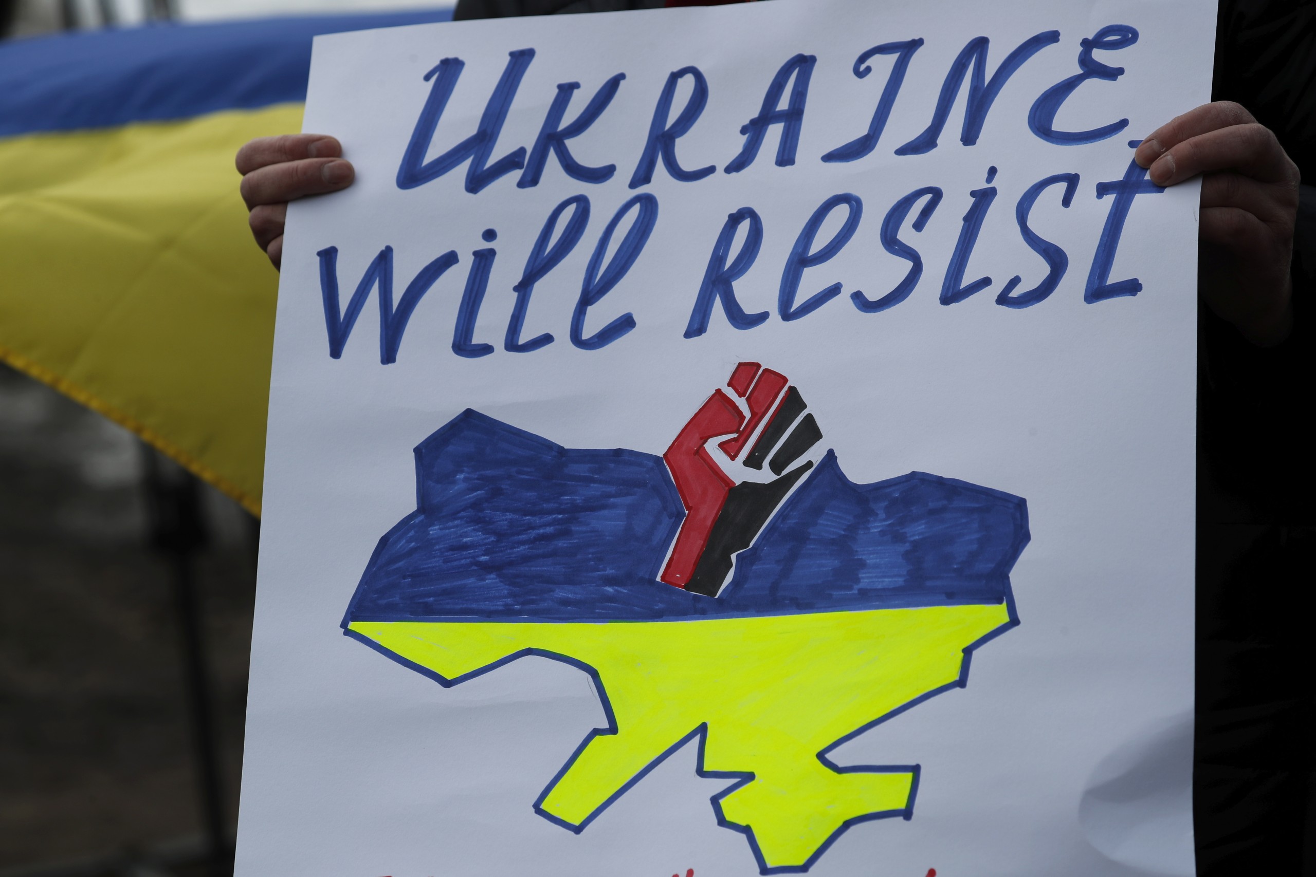 epa09780342 A person holds a placard as people protest against Russia's military operation in Ukraine, outside the Russian Embassy in Riga, Latvia, 24 February 2022. Russian troops entered Ukraine on 24 February. Country's President Volodymyr Zelensky addressed the nation to announce the imposition of martial law.  EPA/TOMS KALNINS