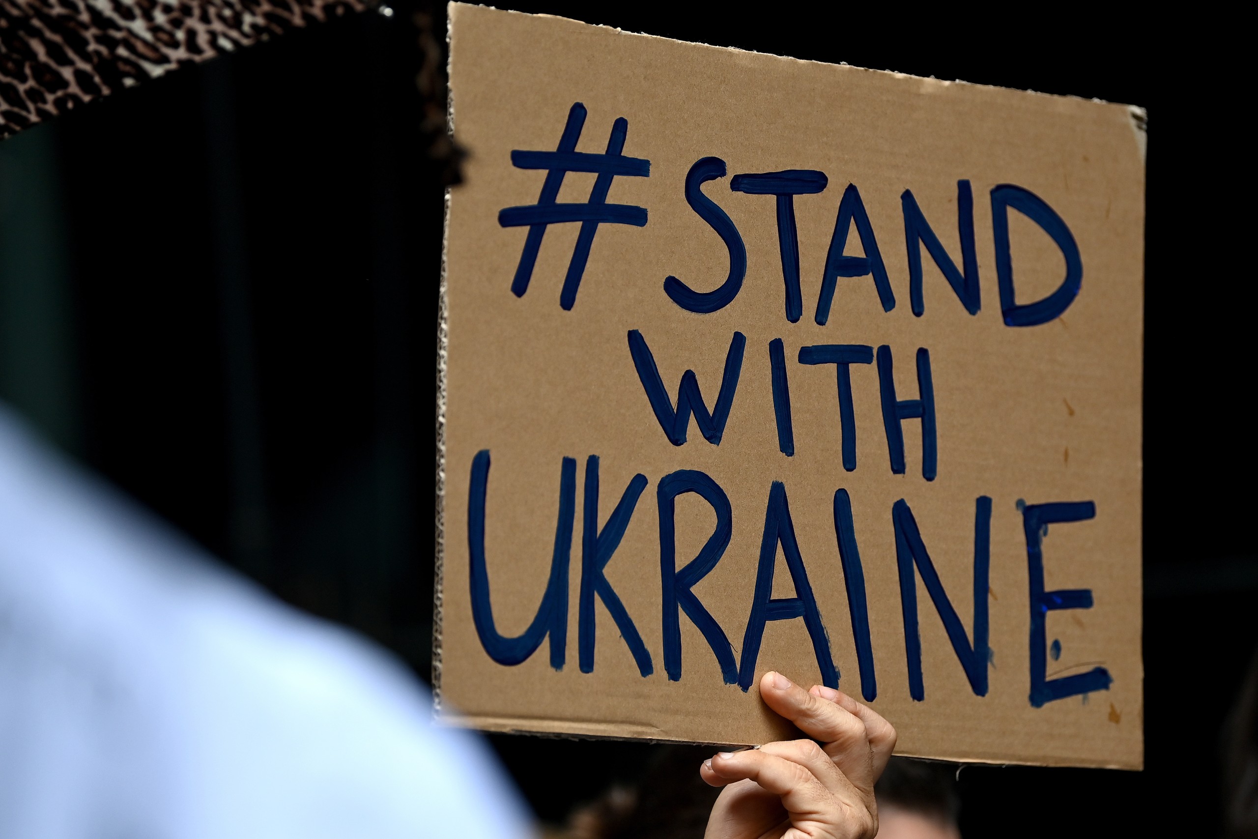 epa09783013 Protesters hold signs during a rally against the war in Ukraine at Martin Place in Sydney, Australia, 25 February 2022.  EPA/BIANCA DE MARCHI  AUSTRALIA AND NEW ZEALAND OUT