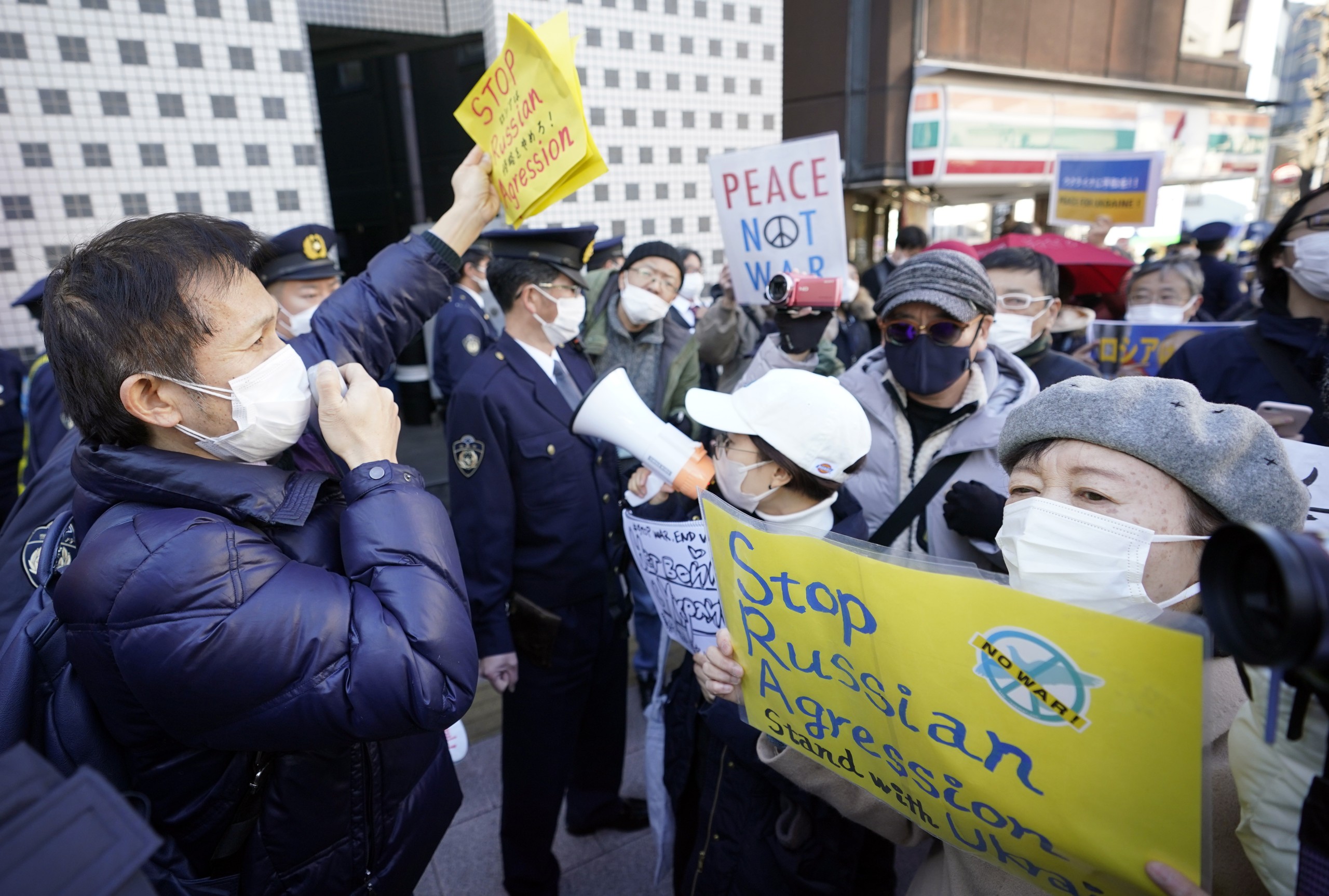 epa09783460 People shout slogans as they protest against Russia's invasion of Ukraine, outside the Russian Embassy in Tokyo, Japan, 25 February 2022. Japan's Prime Minister Fumio Kishida said he will impose sanctions against Russia following its invasion of Ukraine. Russian troops entered Ukraine on 24 February.  EPA/FRANCK ROBICHON