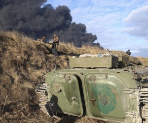 epa09788440 Ukrainian servicemen have a rest on a position looking at smoke from a burned petroleum storage depot behind after a Russian missile attacked near Kiev, Ukraine, 27 February 2022. Russian troops entered Ukraine on 24 February prompting the country's president to declare martial law and triggering a series of announcements by Western countries to impose severe economic sanctions on Russia.  EPA/ALISA YAKUBOVYCH