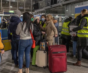 epa09790338 Ukrainian refugees arriving from Kyiv (Kiev) stand with their luggage while being assisted by the volunteers at a train station in Warsaw, Poland, 27 February 2022. Poland is expecting thousands of Ukrainian refugees to cross the country's border in the days to come, as about 200,000 had already entered Poland. Russian troops entered Ukraine on 24 February prompting the country's president to declare martial law and triggering a series of severe economic sanctions imposed by Western countries on Russia.  EPA/ROMAN PILIPEY
