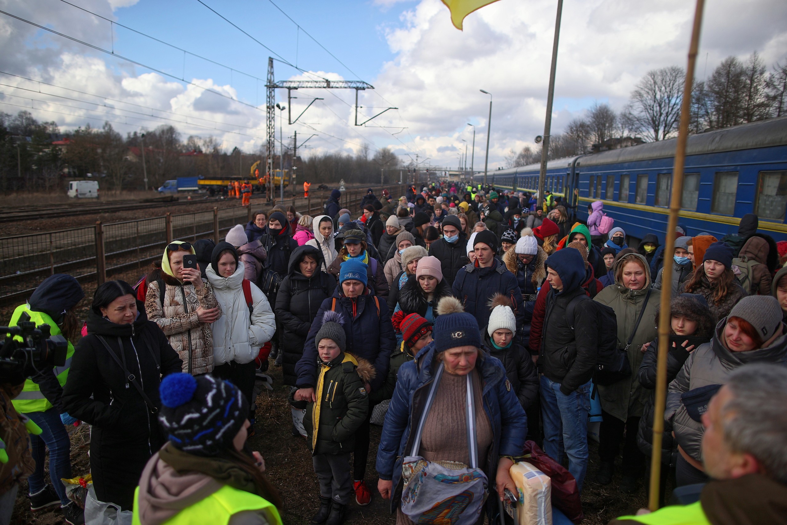 epa09791458 Ukrainians arriving with a humanitarian train from Lviv, stay at the campsite organized next to the Olkusz train station in Olkusz, Poland, 28 February 2022. Refugees will be able to benefit from medical assistance and Ukrainian language interpreters. Then, citizens of Ukraine will be transported by bus to accommodation places indicated by the Malopolska Region.  EPA/£UKASZ GAGULSKI POLAND OUT