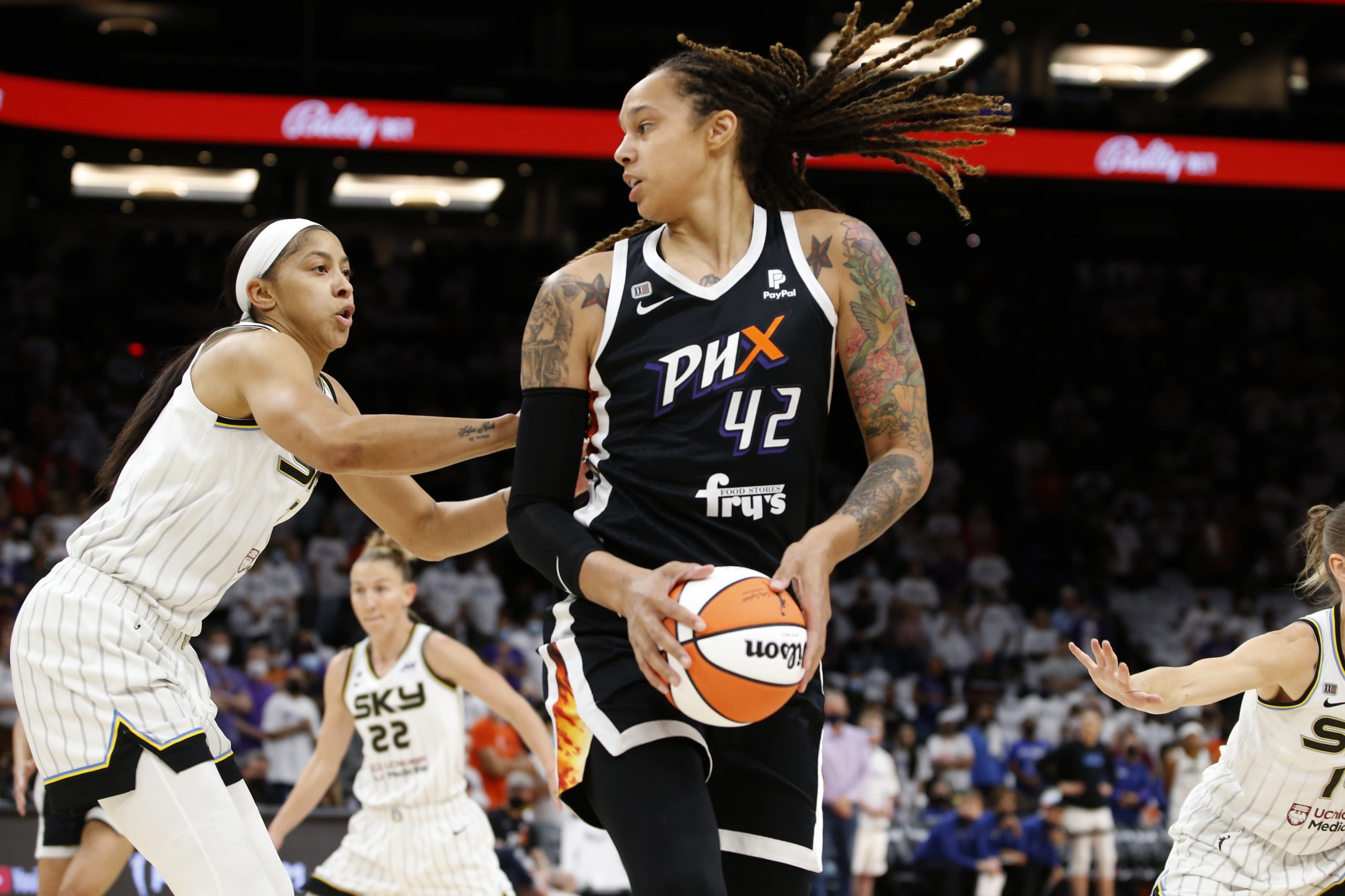 FILE - Phoenix Mercury center Brittney Griner (42) looks to pass as Chicago Sky center Candace Parker defends during the first half of game 1 of the WNBA basketball Finals , Sunday, Oct. 10, 2021, in Phoenix.   Griner was arrested in Russia last month at a Moscow airport after a search of her luggage revealed vape cartridges. The Russian Customs Service said Saturday, March 5, 2022,  that the cartridges were identified as containing oil derived from cannabis, which could carry a maximum penalty of 10 years in prison. The customs service identified the person arrested as a female player for the U.S. national team and did not specify the date of her arrest. (AP Photo/Ralph Freso, File)