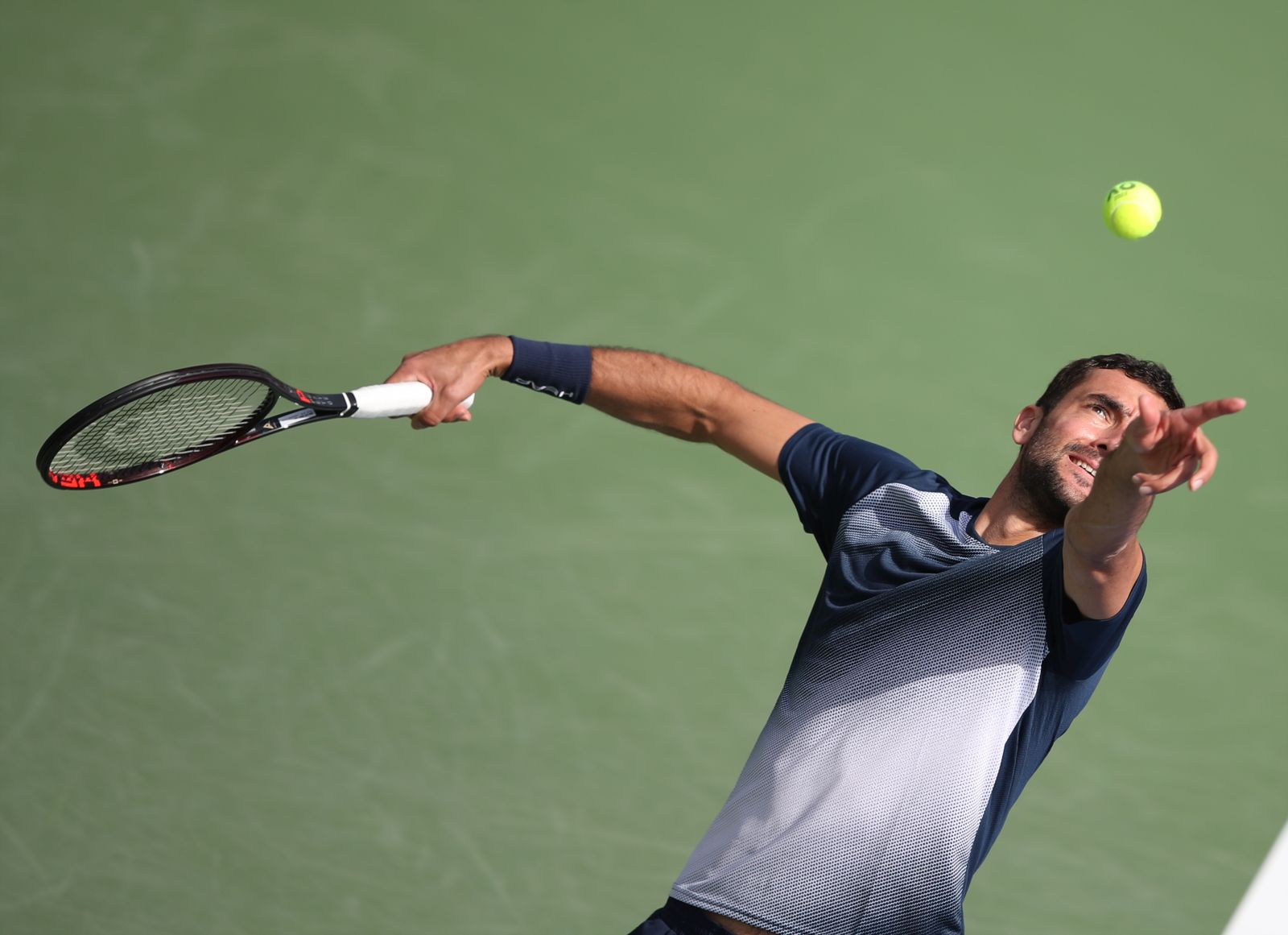 epa09775438 Marin Cilic of Croatia in action during his first round match against Jiri Vesely of the Czech Republic at the Dubai Duty Free Tennis ATP Championships 2022 in Dubai, United Arab Emirates, 21 February 2022.  EPA/ALI HAIDER