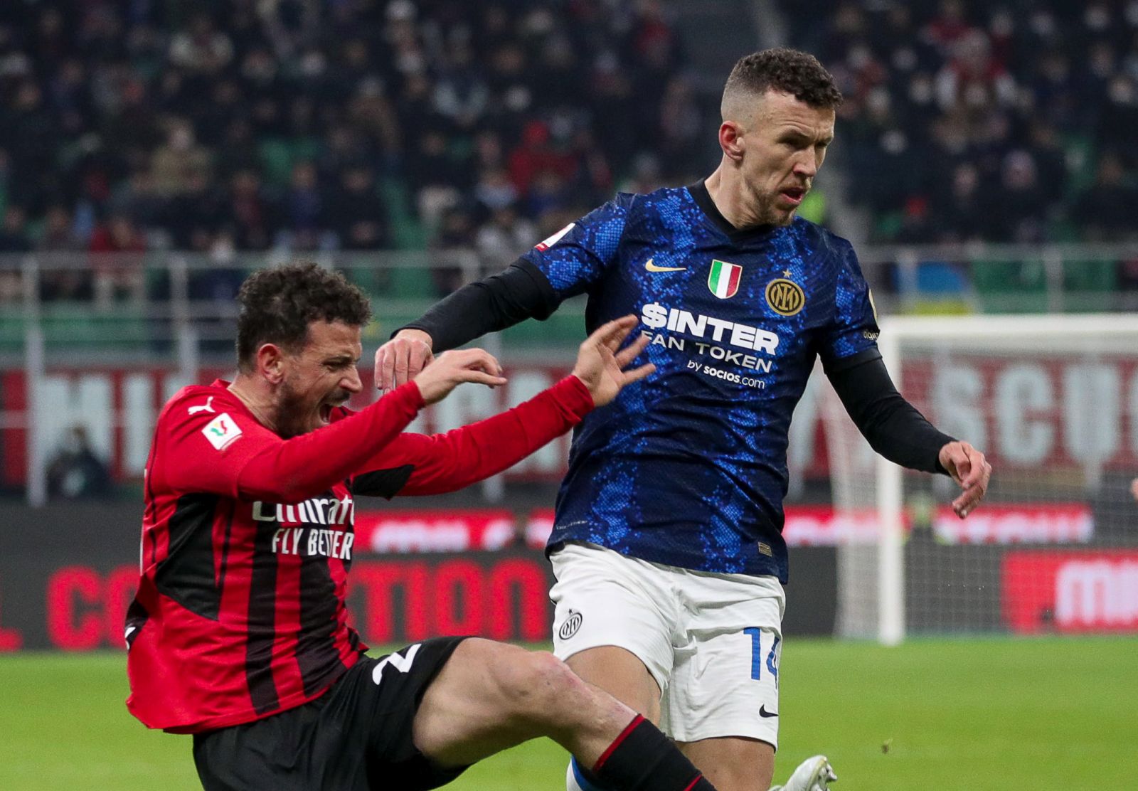 epa09794734 FC Inter's forward Edin Dzeko in action against AC Milan's defender Alessandro Florenzi (L) during the Italian Cup semi final soccer match between AC Milan and FC Inter at Giuseppe Meazza Stadium in Milan, Italy, 01 March 2022.  EPA/ROBERTO BREGANI