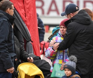 epa09796124 Polish Prime Minister Mateusz Morawiecki (L) and European Council President Charles Michel (R) comfort a woman during their visit to the Polish-Ukrainian border crossing point Korczowa-Krakowiec, Poland, 02 March 2022. Russian troops entered Ukraine on 24 February prompting the country's president to declare martial law and triggering a series of announcements by Western countries to impose severe economic sanctions on Russia.  EPA/DAREK DELMANOWICZ POLAND OUT