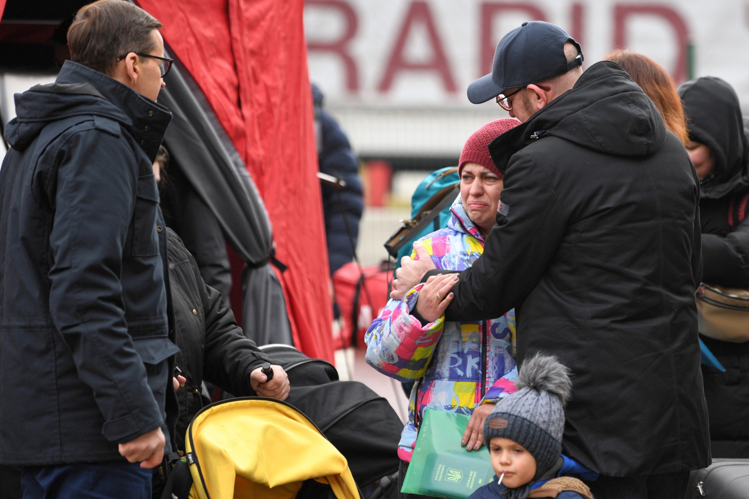 epa09796124 Polish Prime Minister Mateusz Morawiecki (L) and European Council President Charles Michel (R) comfort a woman during their visit to the Polish-Ukrainian border crossing point Korczowa-Krakowiec, Poland, 02 March 2022. Russian troops entered Ukraine on 24 February prompting the country's president to declare martial law and triggering a series of announcements by Western countries to impose severe economic sanctions on Russia.  EPA/DAREK DELMANOWICZ POLAND OUT
