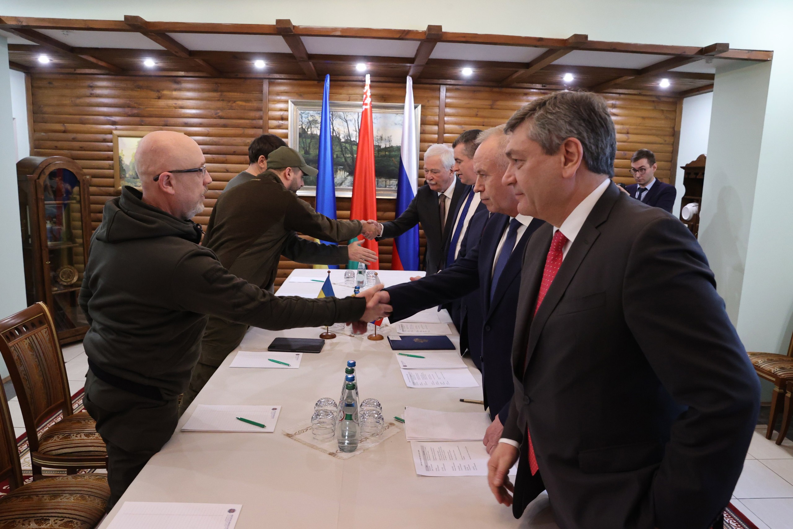 epa09799176 A handout photo made available by BelTA news agency shows Russian (R) and Ukrainian (L) delegations members during the Russia-Ukraine ceasefire negotiations, at an undisclosed location in the Brest region, Belarus, 03 March 2022. Russian troops entered Ukraine on 24 February prompting the country's president to declare martial law and triggering a series of severe economic sanctions imposed by Western countries on Russia.  EPA/MAXIM GUCHEK / BelTA  / HANDOUT MANDATORY CREDIT HANDOUT EDITORIAL USE ONLY/NO SALES