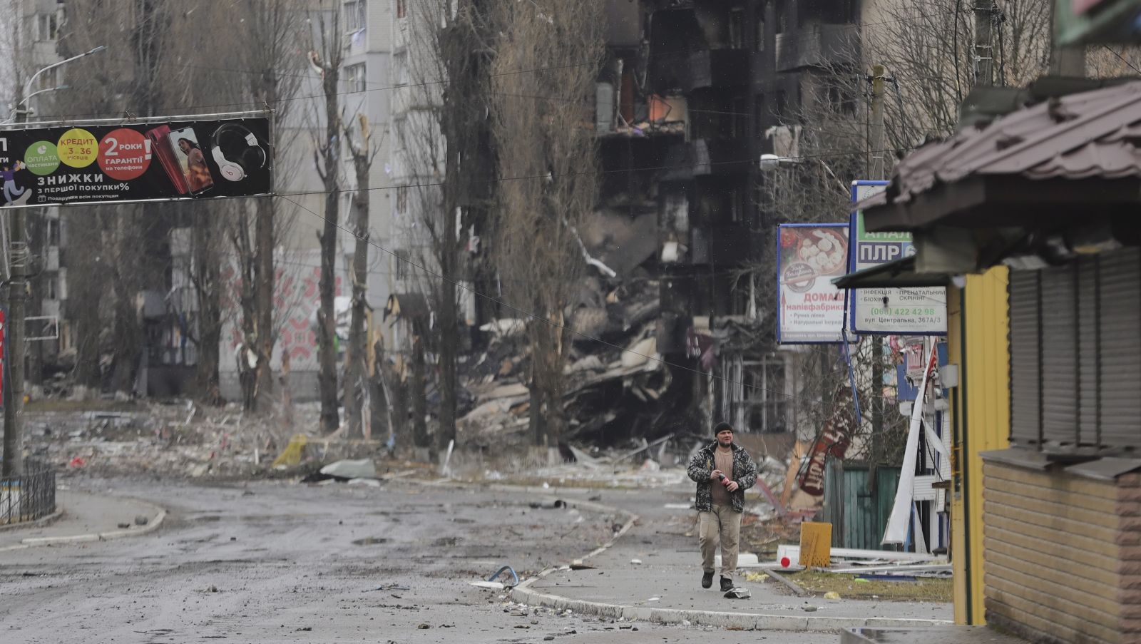 epa09799165 A man goes past burned buildings that were hit by shelling in the small city of Borodyanka near Kiev, Ukraine, 03 March 2022. Russian troops entered Ukraine on 24 February prompting the country's president to declare martial law.  EPA/ALISA YAKUBOVYCH