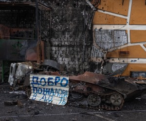 epa09799348 A metal plate with the text 'Welcome to hell' is placed next to a Russian military vehicle destroyed after fightings, in Irpin city, Kyiv (Kiev) province, Ukraine, 03 March 2022. Russian troops entered Ukraine on 24 February prompting the country's president to declare martial law and triggering a series of severe economic sanctions imposed by Western countries on Russia.  EPA/ROMAN PILIPEY