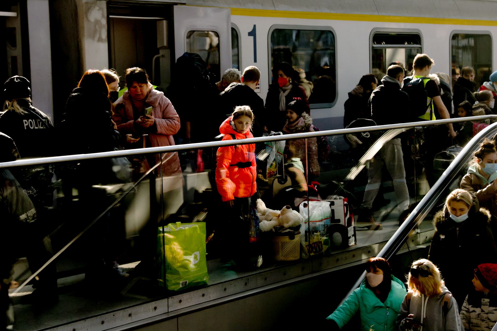 epa09812652 Arriving passengers from a train carrying Ukrainian refugees from Poland at Berlin central station Hauptbahnhof in Berlin, Germany, 09 March 2022.  According to the UNHCR, Russia's military invasion of Ukraine, which started on 24 February, has caused destruction of civilian infrastructure as well as civilian casualties, with tens of thousands internally displaced and over two million refugees fleeing Ukraine.  EPA/FILIP SINGER