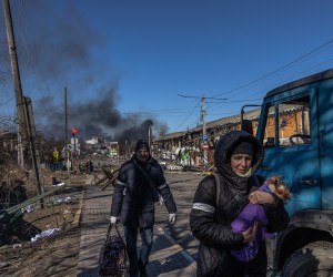 epa09815740 Residents coming from Bucha town, which is currently controlled by the Russian military, walk with luggage past the Ukrainian checkpoint at the frontline in Irpin town, Kyiv (Kiev) region, Ukraine, 10 March 2022. Thousands of residents are feeling Irpin and Bucha, as well as other settlements near Kyiv which were the most affected by the Russian army invasion.  EPA/ROMAN PILIPEY