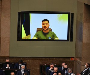 epa09817544 Ukrainian President Volodimir Zelenski (on the screen) speaks during the National Assembly, a joint sitting of both the Polish parliament's houses in Warsaw, Poland, 11 March 2022. The National Assembly was organized to celebrate the 23rd anniversary of Poland's accession to Nato, which falls on 12 March.  EPA/Marcin Obara POLAND OUT