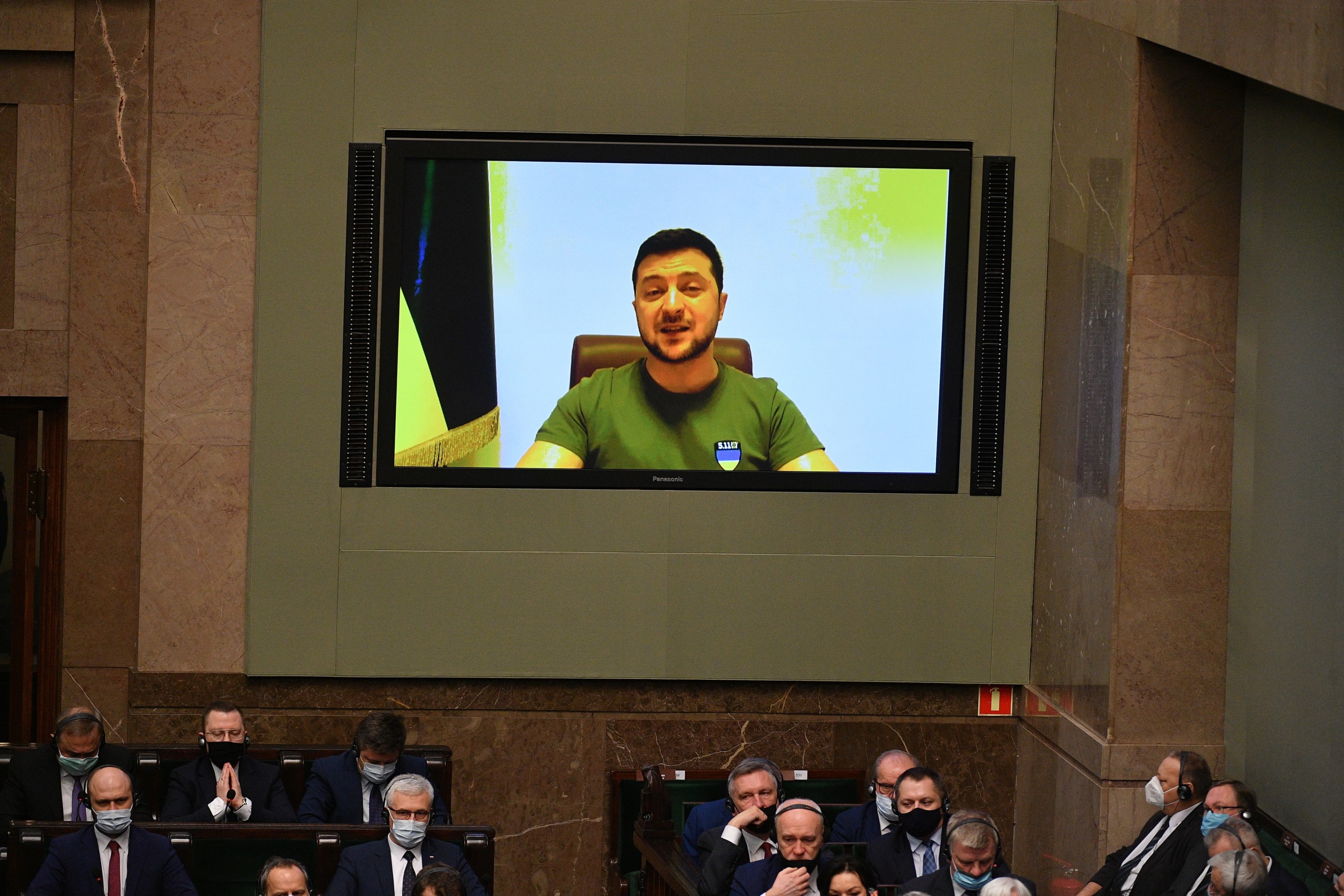 epa09817544 Ukrainian President Volodimir Zelenski (on the screen) speaks during the National Assembly, a joint sitting of both the Polish parliament's houses in Warsaw, Poland, 11 March 2022. The National Assembly was organized to celebrate the 23rd anniversary of Poland's accession to Nato, which falls on 12 March.  EPA/Marcin Obara POLAND OUT