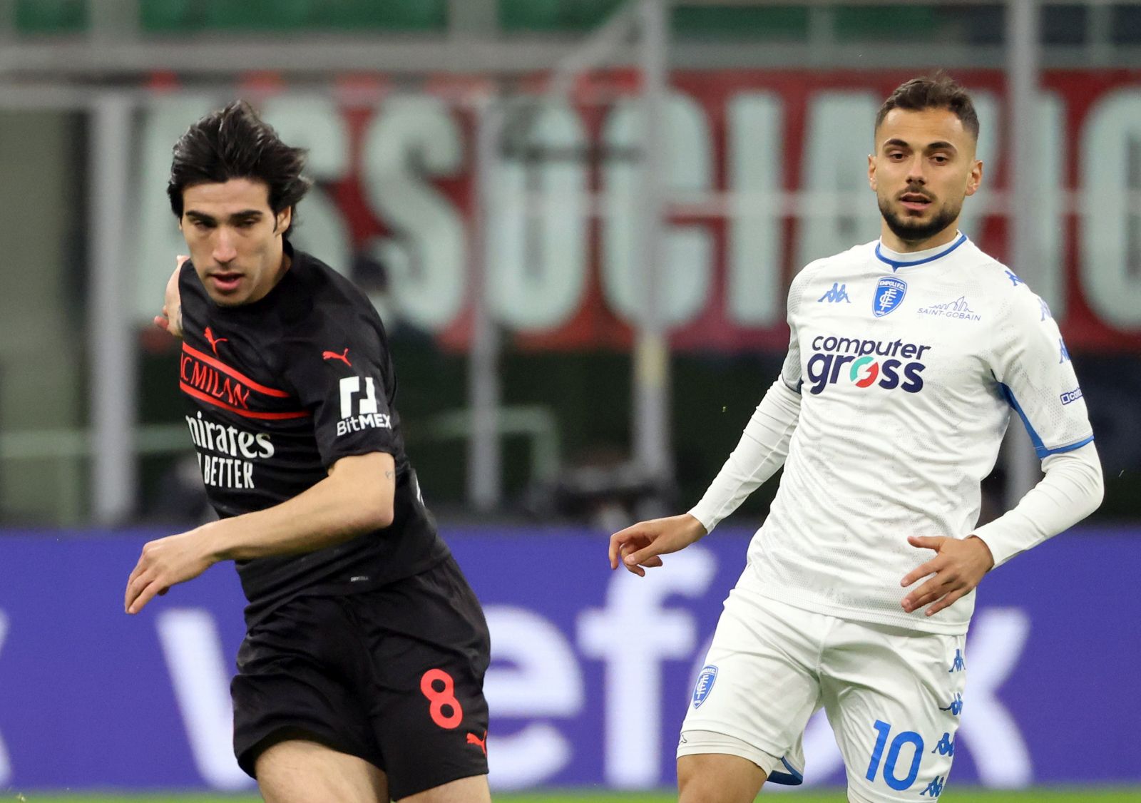 epa09819868 AC Milan’s Sandro Tonali (L) challenges for the ball  with Empoli’s Nedim Bajrami during the Italian Serie A soccer match between AC Milan and Empoli at Giuseppe Meazza stadium in Milan, Italy, 12 March 2022.  EPA/MATTEO BAZZI