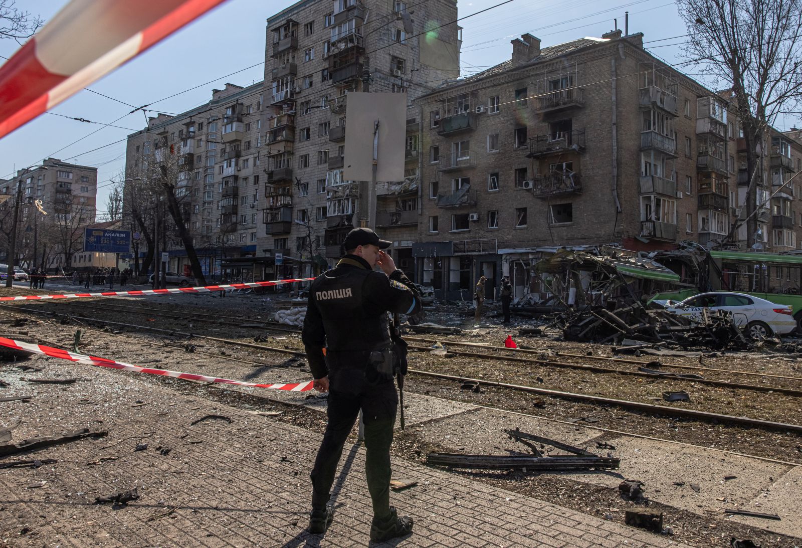 epa09824524 A Ukrainian police officer stands guard at the residential area where the debris of a Russian missile fell after it was shot down, in Kyiv, Ukraine, 14 March 2022. At least one person was killed, Kyiv mayor Klitschko said. Russian troops entered Ukraine on 24 February prompting the country's president to declare martial law and triggering a series of announcements by Western countries to impose severe economic sanctions on Russia.  EPA/ROMAN PILIPEY