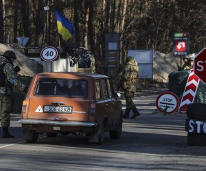 epa09824945 Members of the Territorial Defense Forces check a car in a security check point in Kyiv (Kiev), Ukraine, 14 March 2022. According to the National Guard of Ukraine statistics, 100,000 Ukrainians have joined the Territorial Defense Force since the beginning of the Russian invasion of Ukraine.  EPA/MIGUEL A. LOPES
