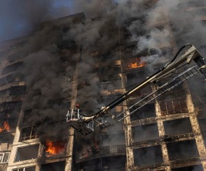 epa09825999 A firefighter extinguishes the fire in a residential building which was hit by artillery shelling, in Kyiv, Ukraine, 15 March 2022. Russian troops entered Ukraine on 24 February prompting the country's president to declare martial law and triggering a series of announcements by Western countries to impose severe economic sanctions on Russia.  EPA/ROMAN PILIPEY