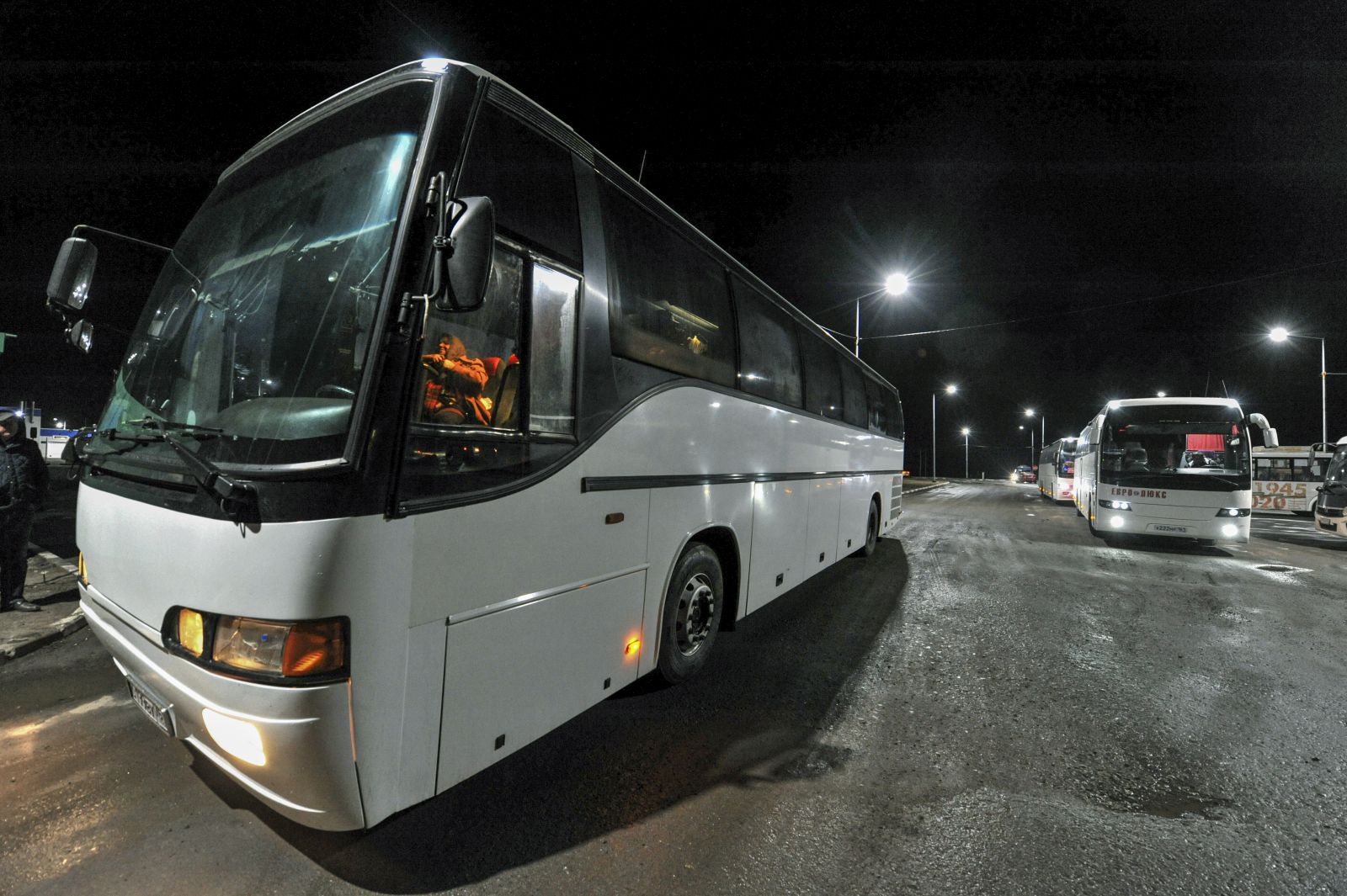 epa09827545 Buses with people evacuated from Mariupol arrive to the Ukraine-Russia border at the border crossing point Veselo-Voznesenka in the Rostov region, Russia, 15 March 2022. Civilians were able to leave the city, on 15 March, thanks to humanitarian corridors organised by the Russian military, with housing and food have been prepared in Russia for those who fled from Mariupol. On 24 February Russian troops had entered Ukrainian territory in what the Russian president declared a 'special military operation', resulting in fighting and destruction in the country, a huge flow of refugees, and multiple sanctions against Russia.  EPA/ARKADY BUDNITSKY