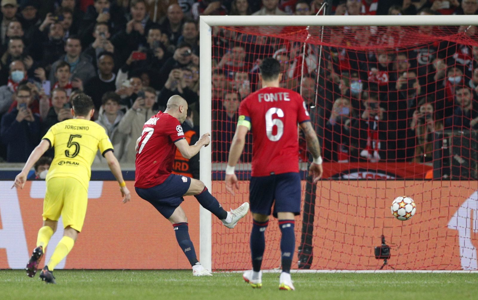 epa09829744 Burak Yilmaz (C) of Lille scores the 1-0 lead from the penalty spot during the UEFA Champions League round of 16, second leg soccer match between Lille OSC (LOSC) and Chelsea FC in Villeneuve d'Ascq, near Lille, France, 16 March 2022.  EPA/Yoan Valat