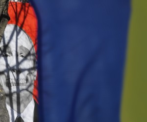 epa09831413 A poster of Russian president Putin with a skeletal skull jaw is displayed on the facade of the Museum of Medical History building protest action in front of the Russia Embassy in Riga, Latvia, 17 March 2022. The protest is planned to continue and take place every day at the Russian Embassy in Riga, until the end of the war in Ukraine. On 24 February Russian troops had entered Ukrainian territory in what the Russian president declared a 'special military operation', resulting in fighting and destruction in the country, a huge flow of refugees, and multiple sanctions against Russia.  EPA/TOMS KALNINS