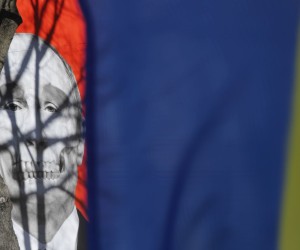 epa09831413 A poster of Russian president Putin with a skeletal skull jaw is displayed on the facade of the Museum of Medical History building protest action in front of the Russia Embassy in Riga, Latvia, 17 March 2022. The protest is planned to continue and take place every day at the Russian Embassy in Riga, until the end of the war in Ukraine. On 24 February Russian troops had entered Ukrainian territory in what the Russian president declared a 'special military operation', resulting in fighting and destruction in the country, a huge flow of refugees, and multiple sanctions against Russia.  EPA/TOMS KALNINS