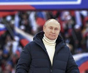 epa09834243 Russian President Vladimir Putin delivers a speech during a concert marking the 8th anniversary of Crimea's reunification with Russia at the Luzhniki stadium in Moscow, Russia, 18 March 2022. The banner holds letter Z and says 'For Russia'. The letter Z, painted on Russian military vehicles in Ukraine, has quickly become a symbol of support a 'special military operation' carried out by the Russian Armed Forces in Ukraine. Russia in 2014 annexed the Black Sea peninsula, shortly after Crimeans voted in a disputed referendum to secede from Ukraine.  EPA/RAMIL SITDIKOV / SPUTNIK POOL