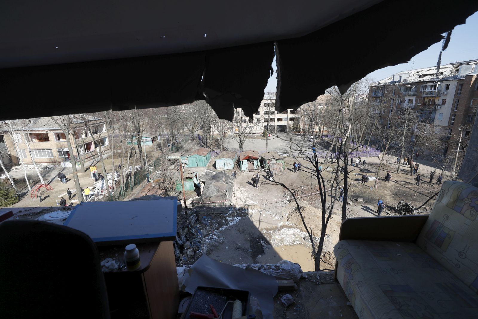 epa09835869 Ukrainians inspect a partially damaged building by Russian missiles in Kiev (Kyiv), Ukraine, 19 March 2022. On 24 February Russian troops had entered Ukrainian territory in what the Russian president declared a 'special military operation', resulting in fighting and destruction in the country, a huge flow of refugees, and multiple sanctions against Russia.  EPA/ATEF SAFADI