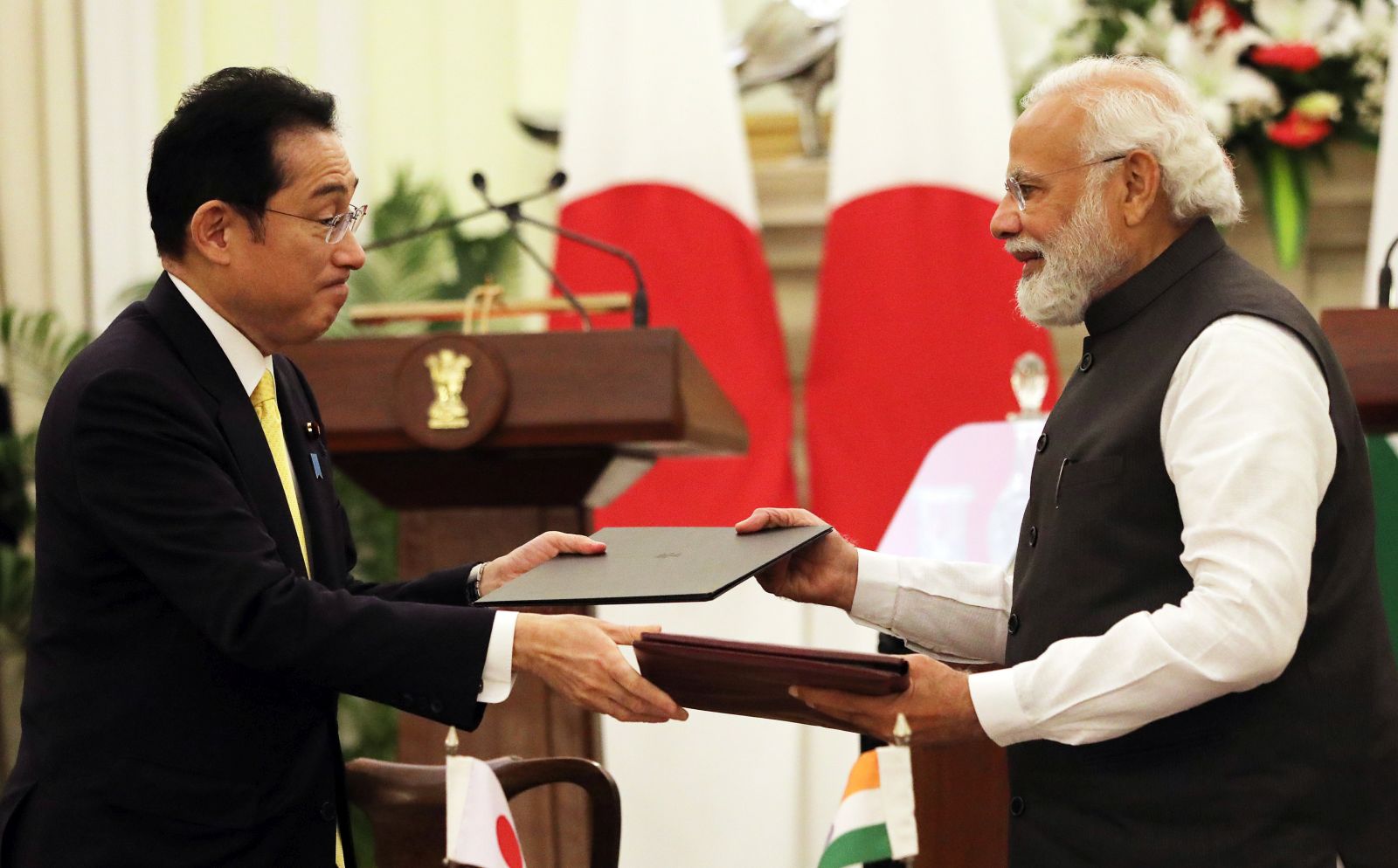 epa09836210 Indian Prime Minister Narendra Modi (R ) and Japanese Prime Minister Fumio Kishida exchange documents after signing the joint statement  in New Delhi, India, 19 March 2022. Prime Minister Fumio Kishida is on a two-day visit to India where he will attend the 14th India-Japan summit. Kishido announced 42 billion US dollar investment target in India over the next five years. India and Japan signed the series of agreements including the cyber security.  EPA/HARISH TYAGI