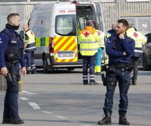 epa09837571 Police officers stand guard at the cordoned off scene in Strepy Bracquegnies, Belgium, 20 March 2022. Six people lost their lives and 26 were injured in the morning, when a car rammed in a carnival crowd.  EPA/JULIEN WARNAND